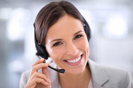 iStock-484193537-Woman-headset-smiling-1